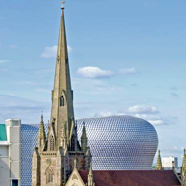 Top of a cathedral and a modern shopping centre in Birmingham