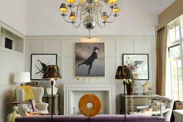 Bright wood-panelled drawing room with art pieces