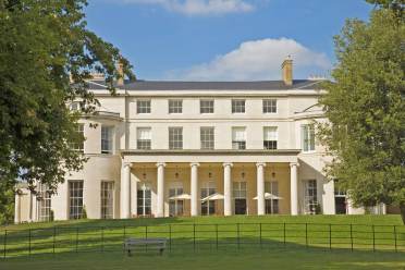 Grand pale-stone mansion with Ionic columns