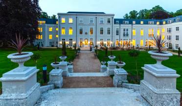 Looking over stone steps to lit terrace in the evening