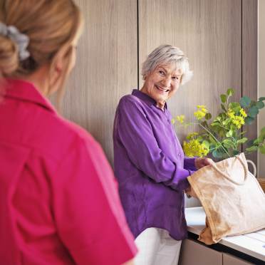 Carer helping woman with shopping