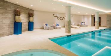 Indoor swimming pool with loungers