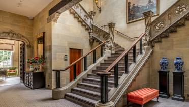 Stone staircase in lobby at Audley Sunningdale Park Sweeping stone staircase in mansion house