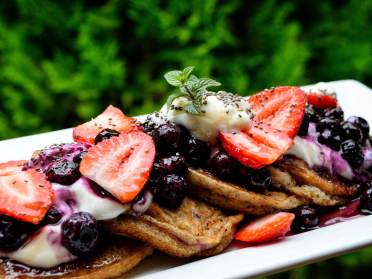 Pancakes with berries on a rectangular plate