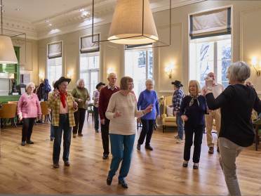 Homeowners line dancing at Mote House, Bearsted Homeowners line dancing together at Mote House Bearsted retirement village